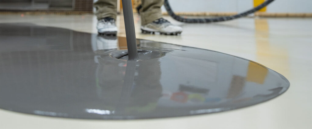 A Maxxon applicator pouring self-leveling underlayment.