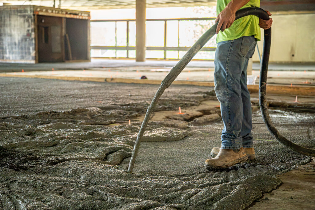 Worker installing Maxxon Low Density Fill during the University of Tennessee Presidential Court Building renovation.
